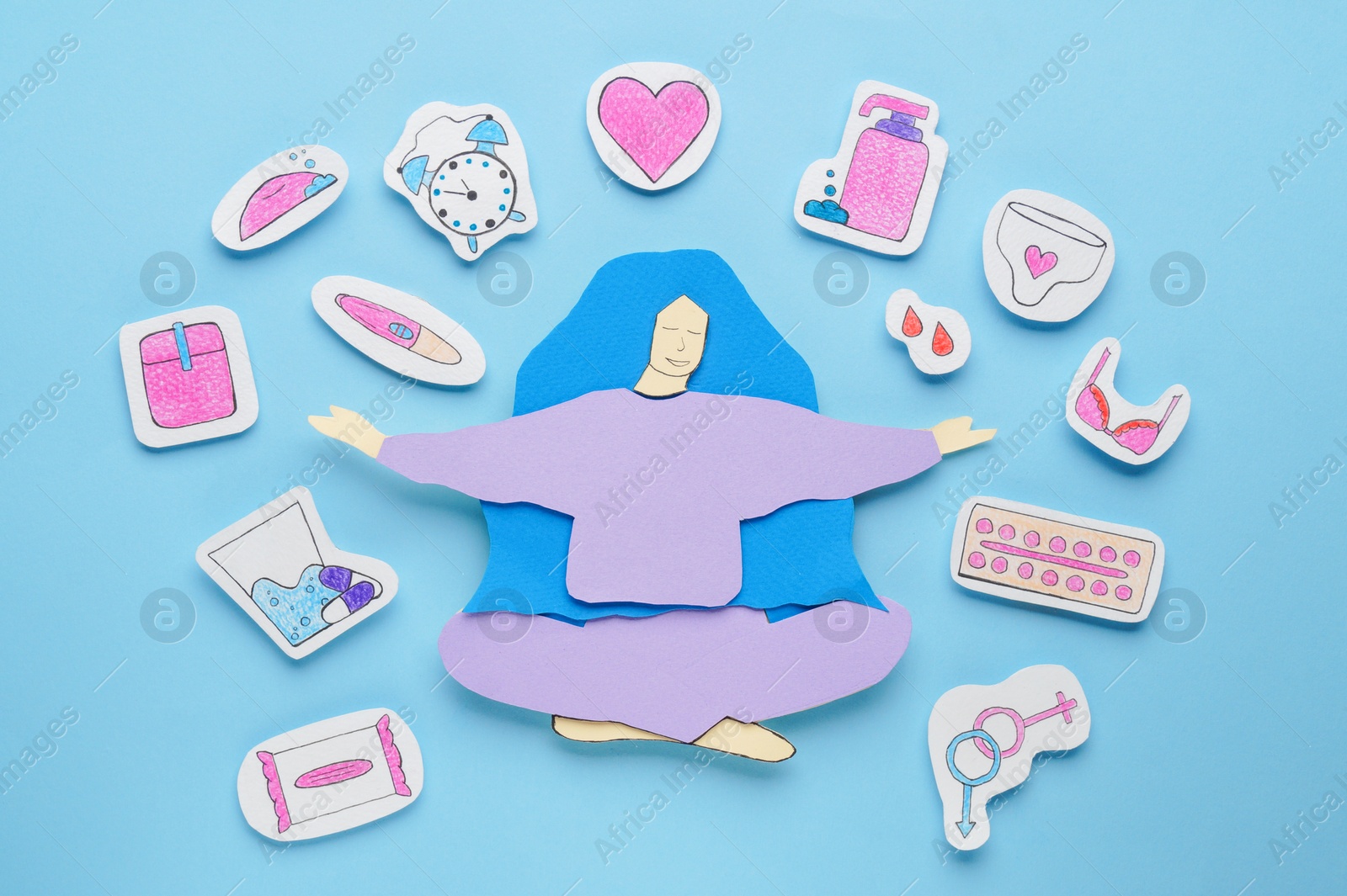 Photo of Woman`s health. Paper female figure and different stickers on light blue background, flat lay