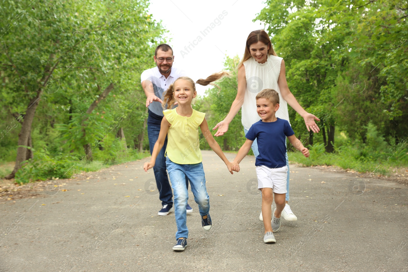 Photo of Happy family spending time together with their children outdoors