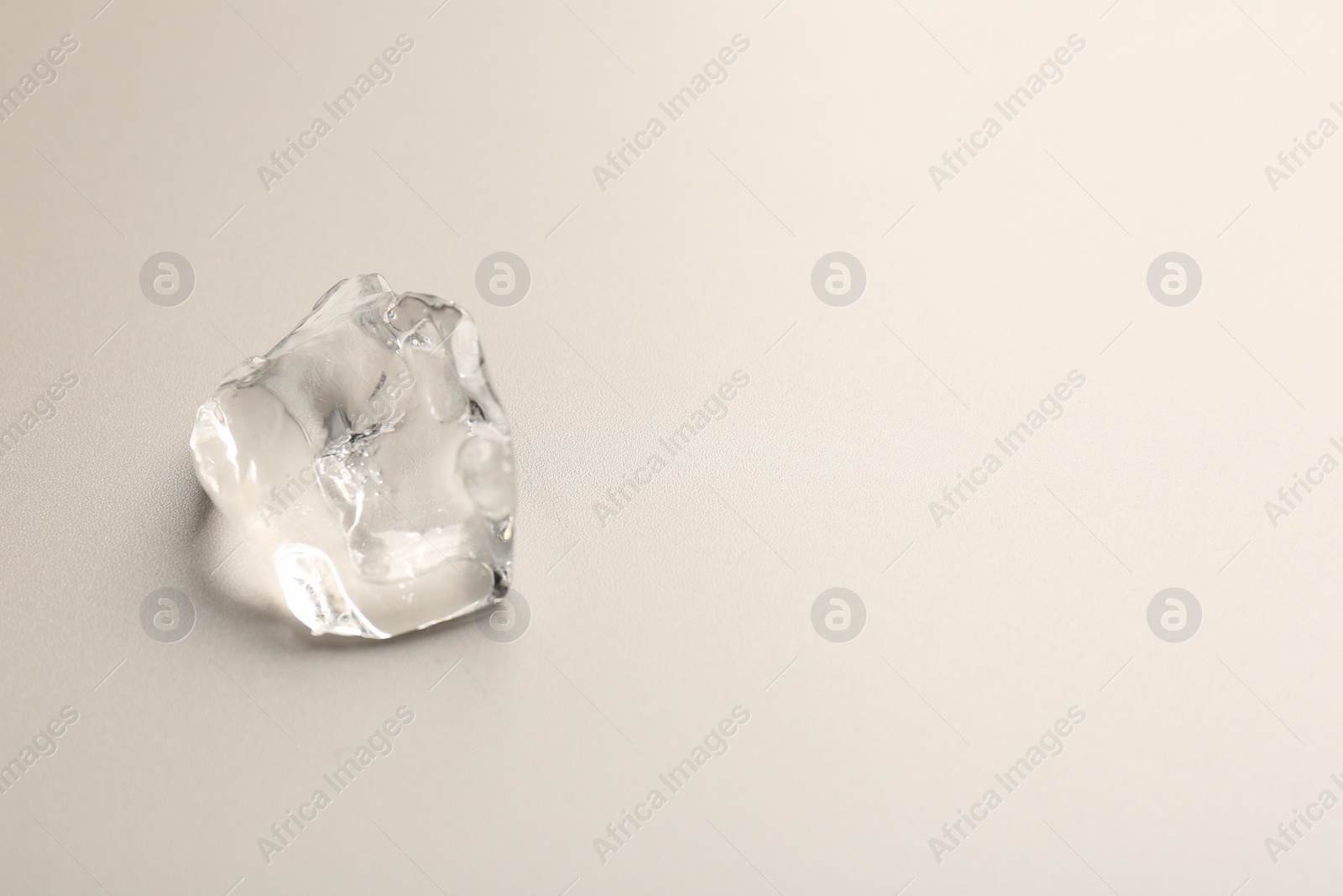 Photo of Piece of crushed ice on grey background, top view. Space for text