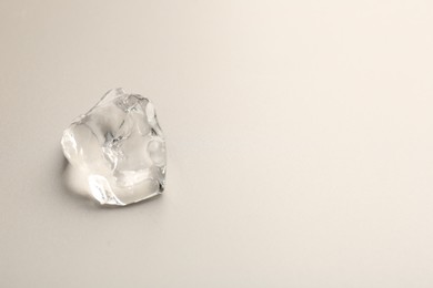 Photo of Piece of crushed ice on grey background, top view. Space for text
