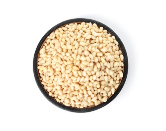 Plate with pine nuts on white background, top view