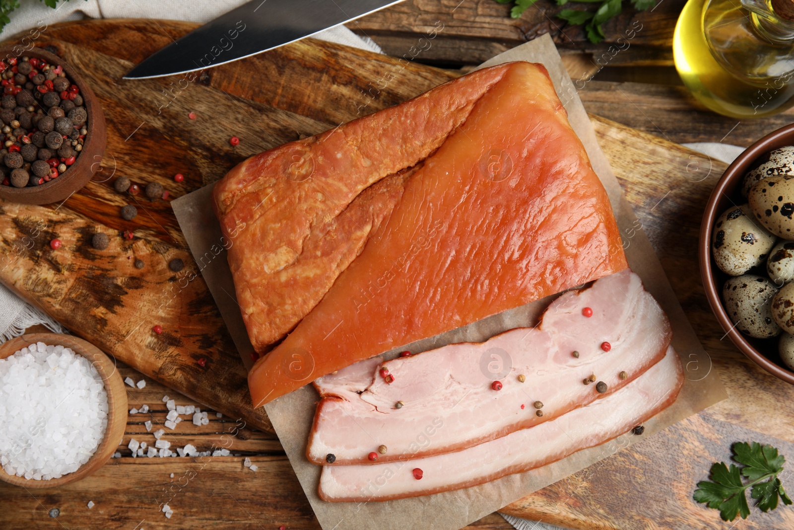 Photo of Flat lay composition with delicious smoked bacon on wooden table