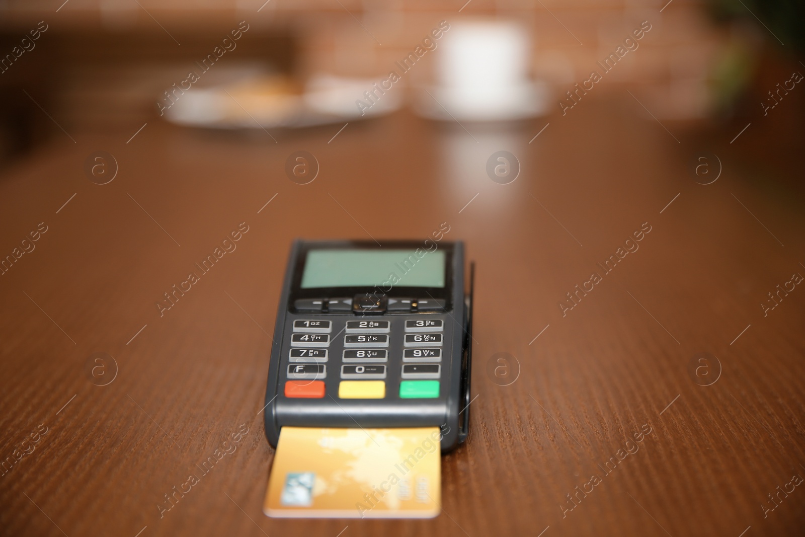 Photo of Terminal for contactless payment on table in restaurant