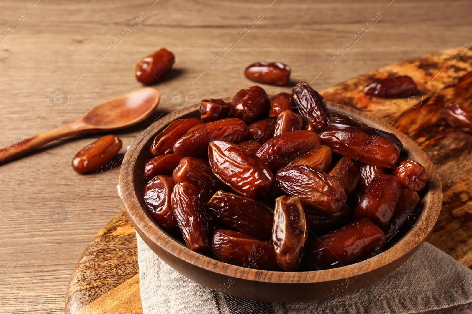 Photo of Tasty sweet dried dates on wooden table