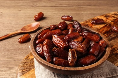 Tasty sweet dried dates on wooden table