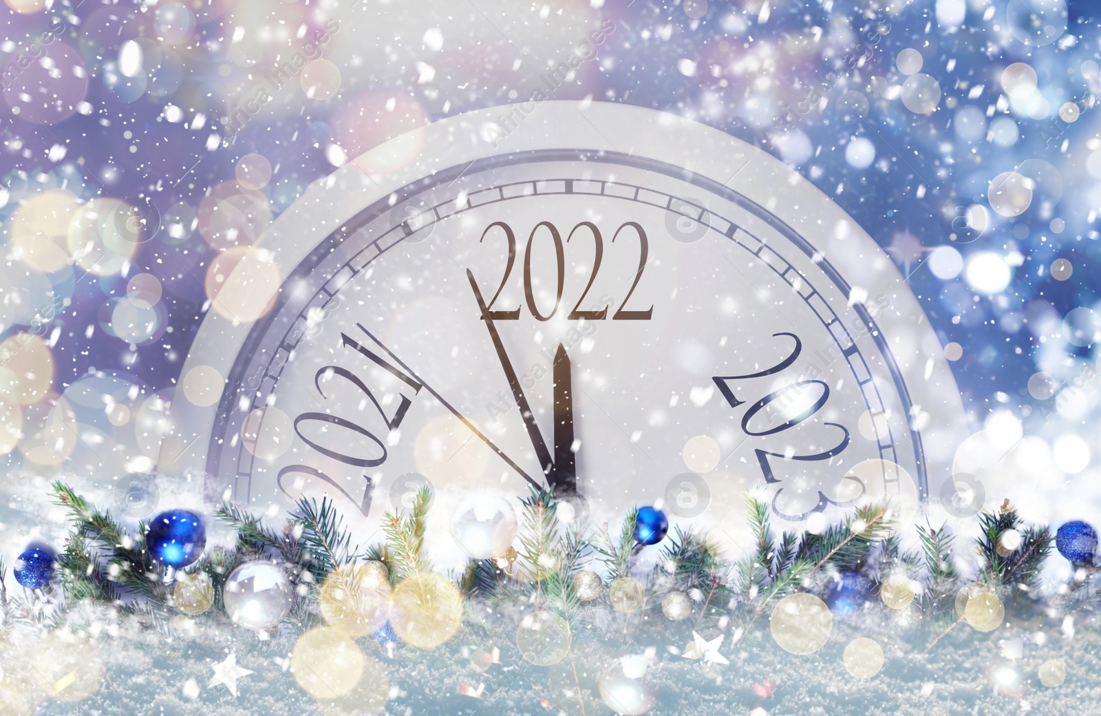 Image of Clock counting last moments to New 2022 Year and beautiful fir branches with baubles. Bokeh effect