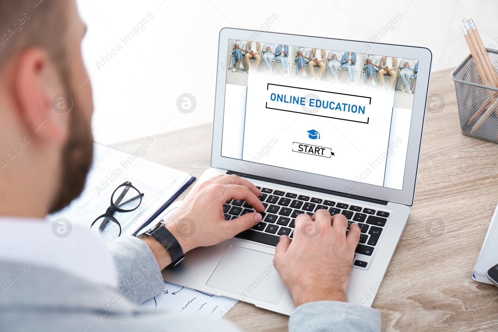 Image of Man using laptop for online studying indoors, closeup. Adult education 