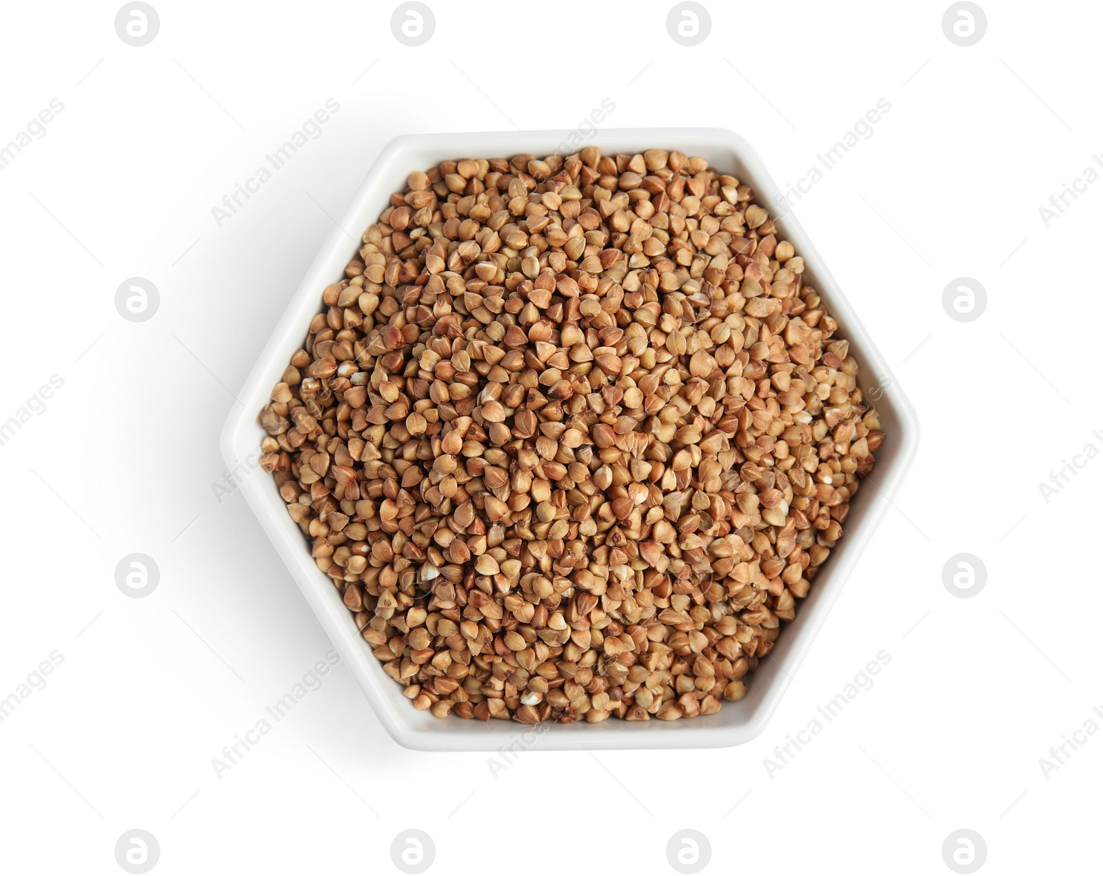 Photo of Bowl with uncooked buckwheat on white background, top view