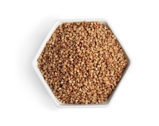 Bowl with uncooked buckwheat on white background, top view