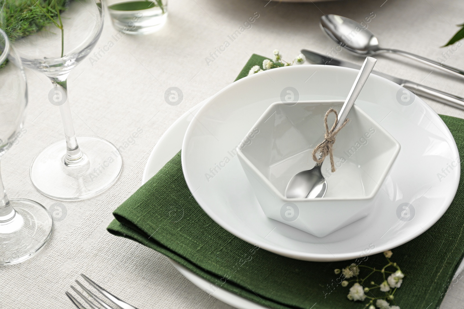 Photo of Stylish tableware and plants on table. Festive setting