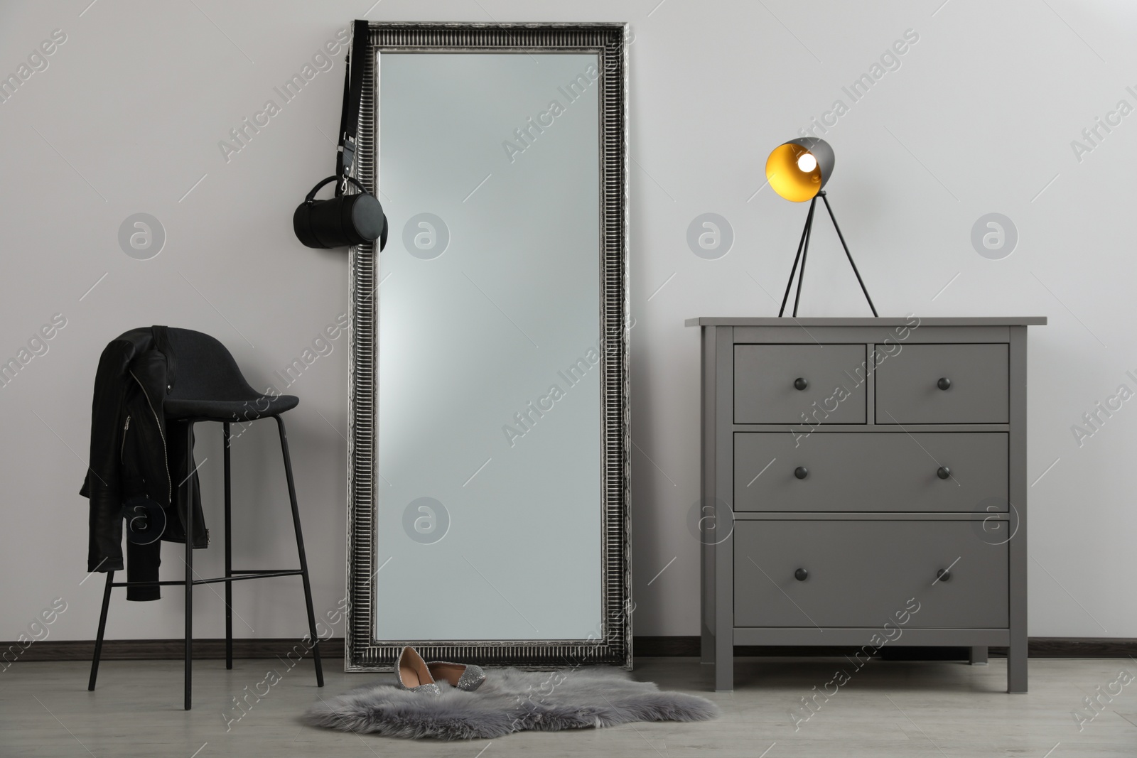 Photo of Stylish room interior with leaning floor mirror