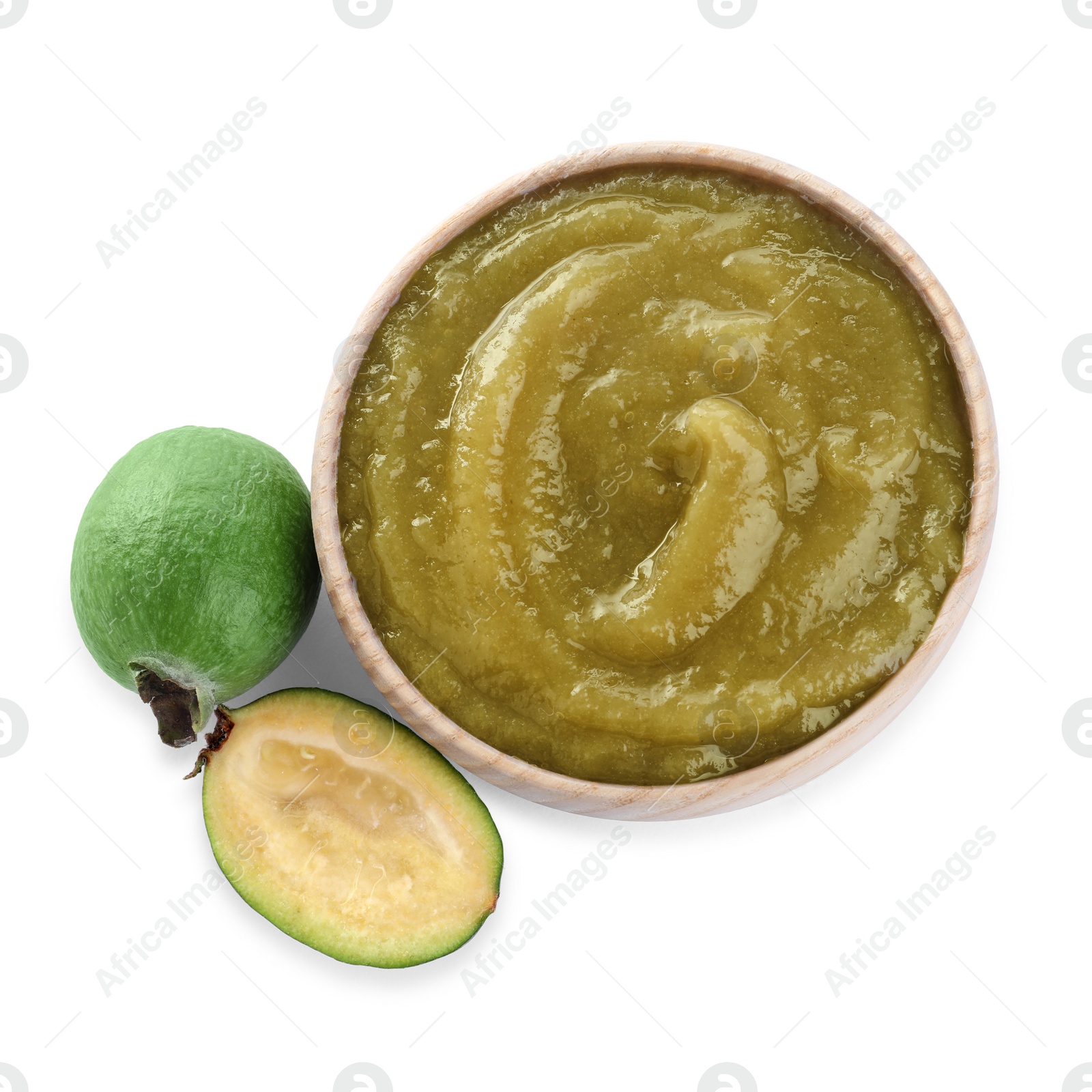 Photo of Feijoa jam in wooden bowl and fresh fruits on white background, top view