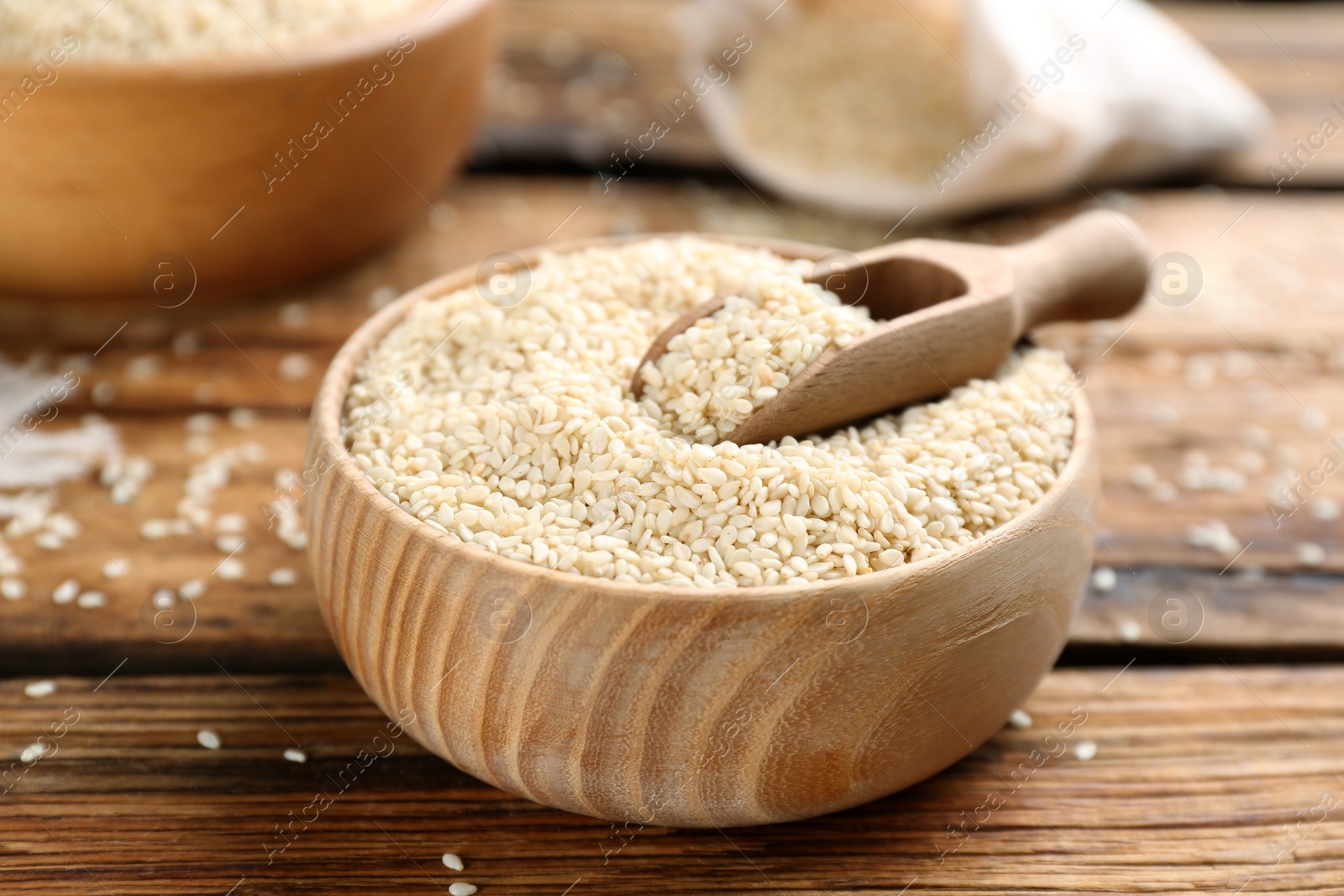 Photo of White sesame seeds on wooden table, closeup