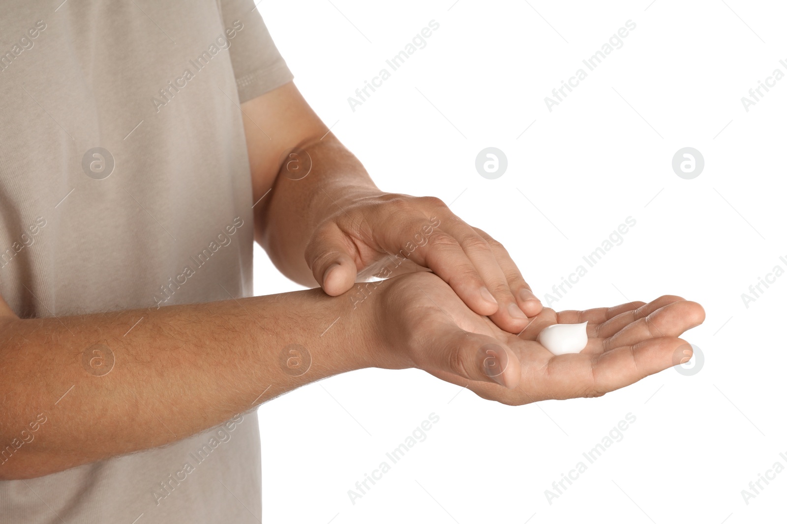 Photo of Man applying cream on hands against white background, closeup