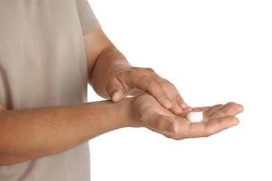 Photo of Man applying cream on hands against white background, closeup