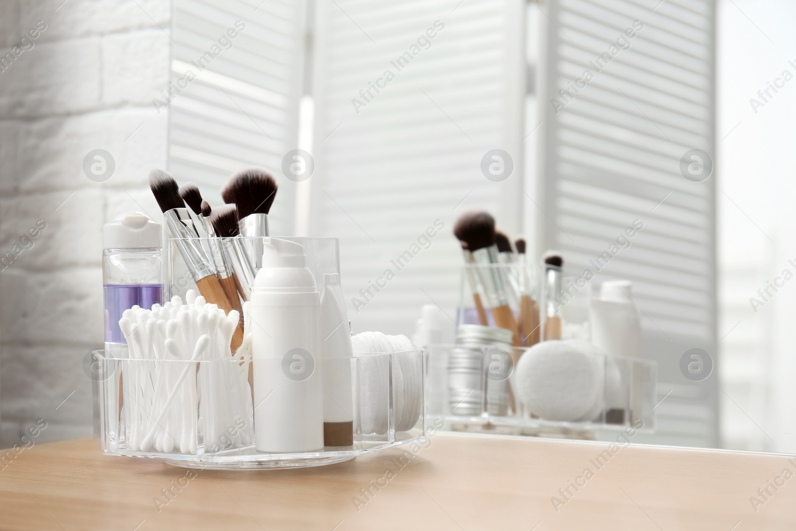 Photo of Organizer with cosmetic products and space for text on dressing table