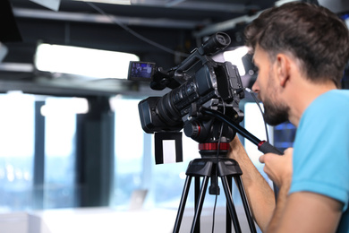 Photo of Professional video camera operator working in studio, closeup