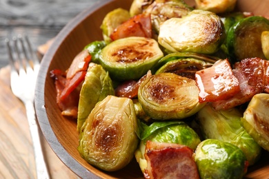 Image of Delicious fried Brussels sprouts with bacon in bowl, closeup