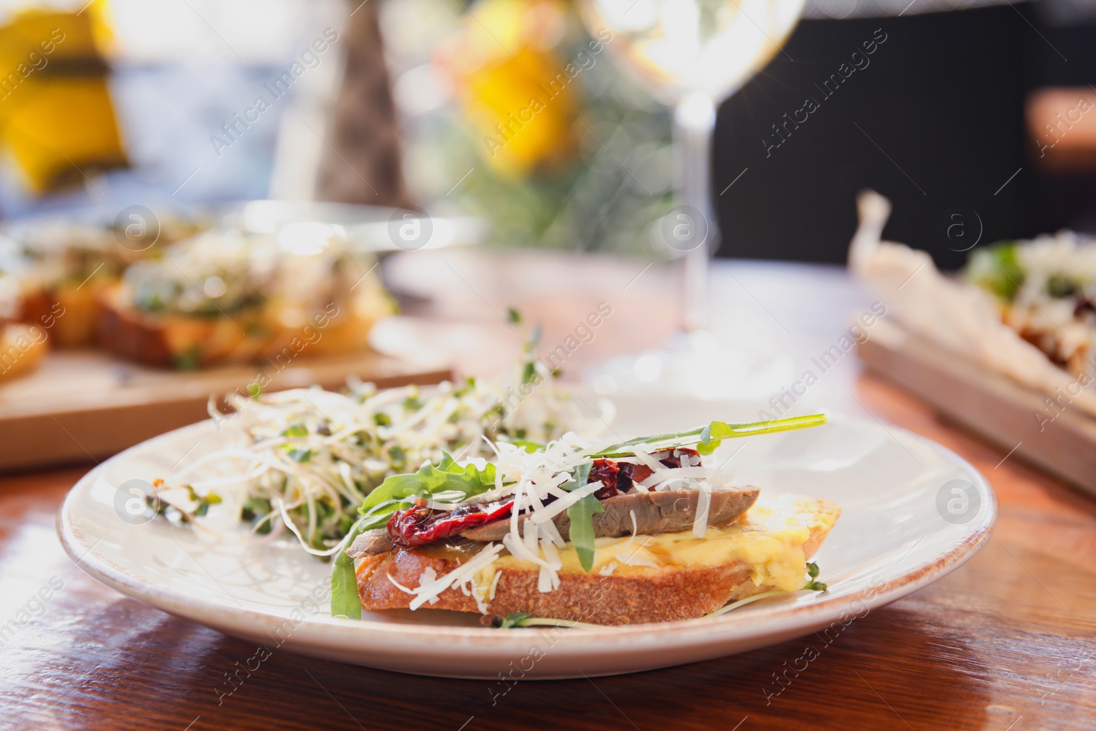 Photo of Delicious bruschettas served on wooden table in cafe