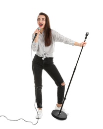 Photo of Young woman in casual clothes singing with microphone on white background