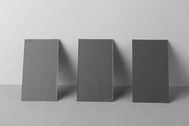 Photo of Blank black business cards on grey background. Mockup for design
