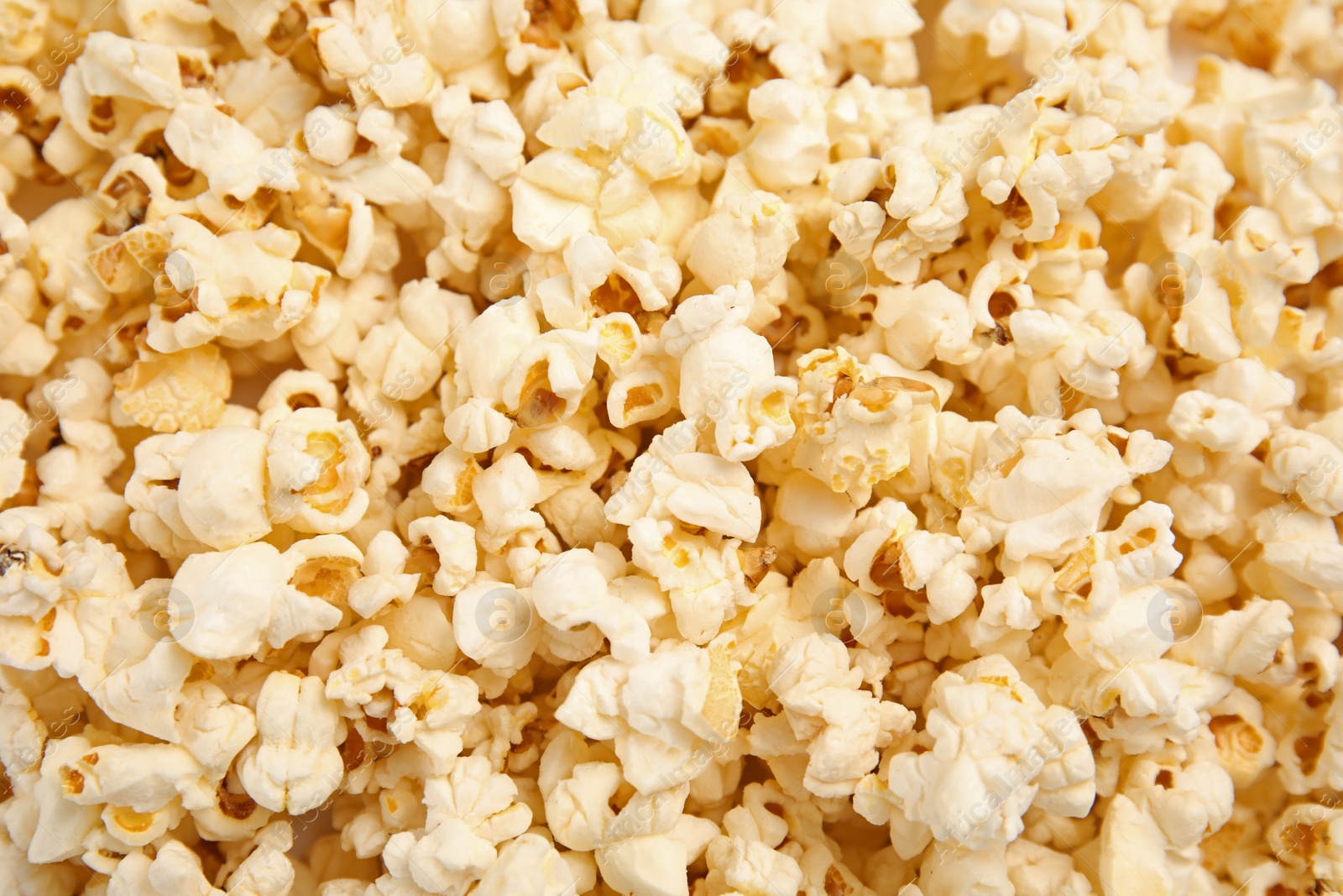 Photo of Tasty fresh popcorn as background, top view