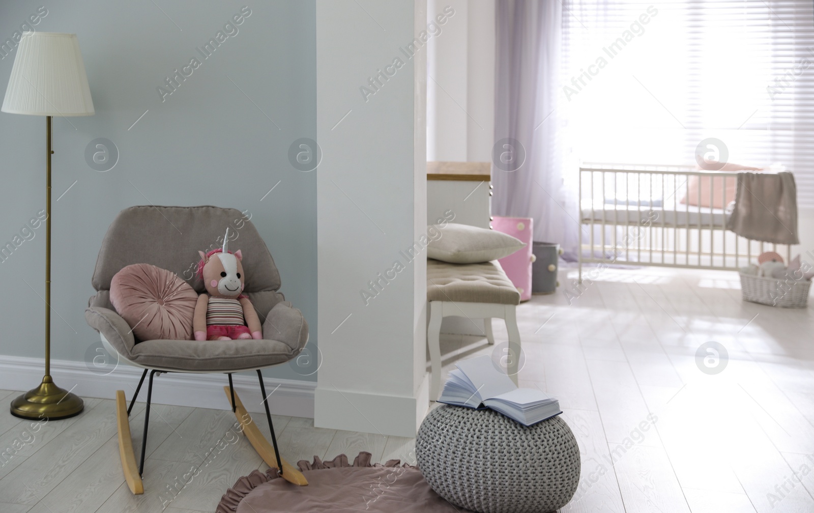 Photo of Cozy baby room interior with comfortable rocking chair
