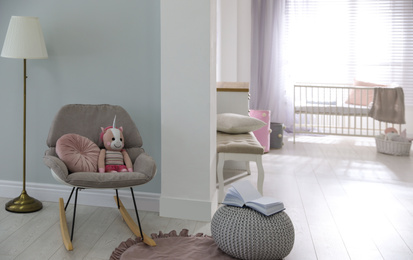 Cozy baby room interior with comfortable rocking chair