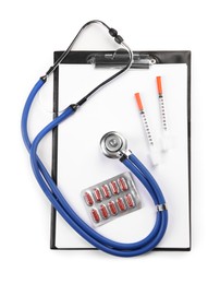 Photo of Stethoscope, pills, syringes and clipboard isolated on white, top view. Medical tools