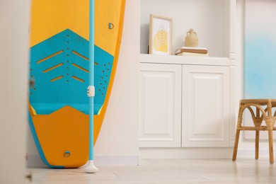 SUP board and furniture in room. Interior design