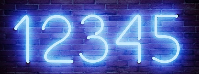 Image of Glowing neon number (1, 2, 3, 4, 5) signs on brick wall