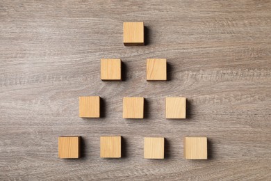Photo of Blank cubes on wooden table, flat lay