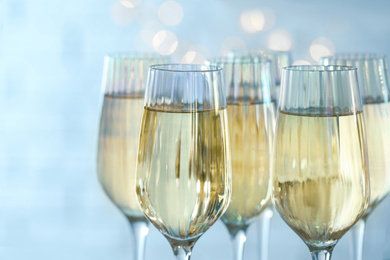 Photo of Glasses of champagne against blurred lights, closeup