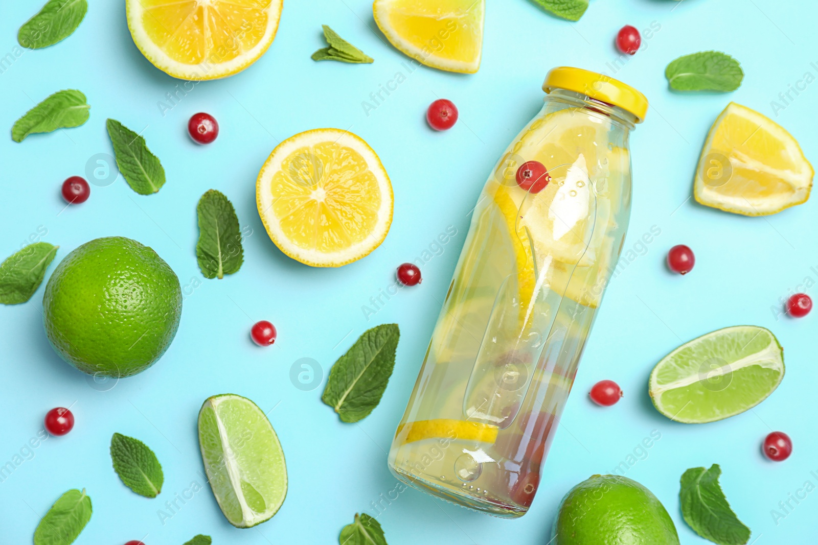 Photo of Flat lay composition with delicious natural lemonade on color background