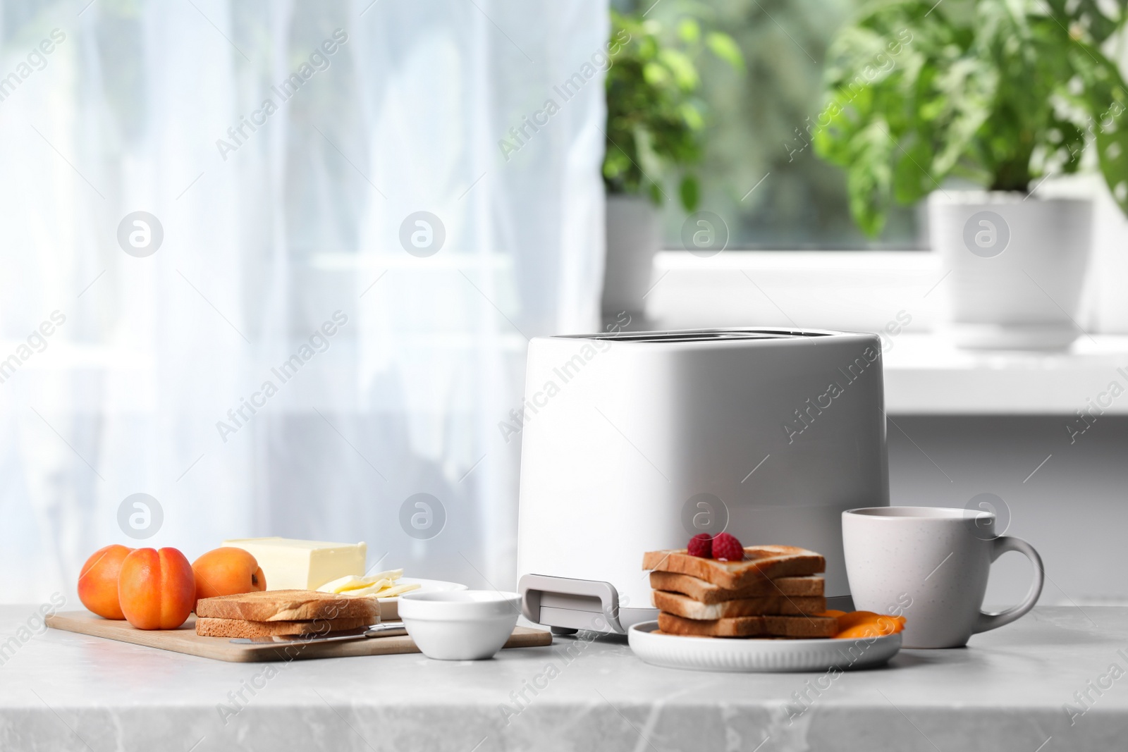 Photo of Toaster, roasted bread and coffee on light gray marble table, space for text. Tasty breakfast