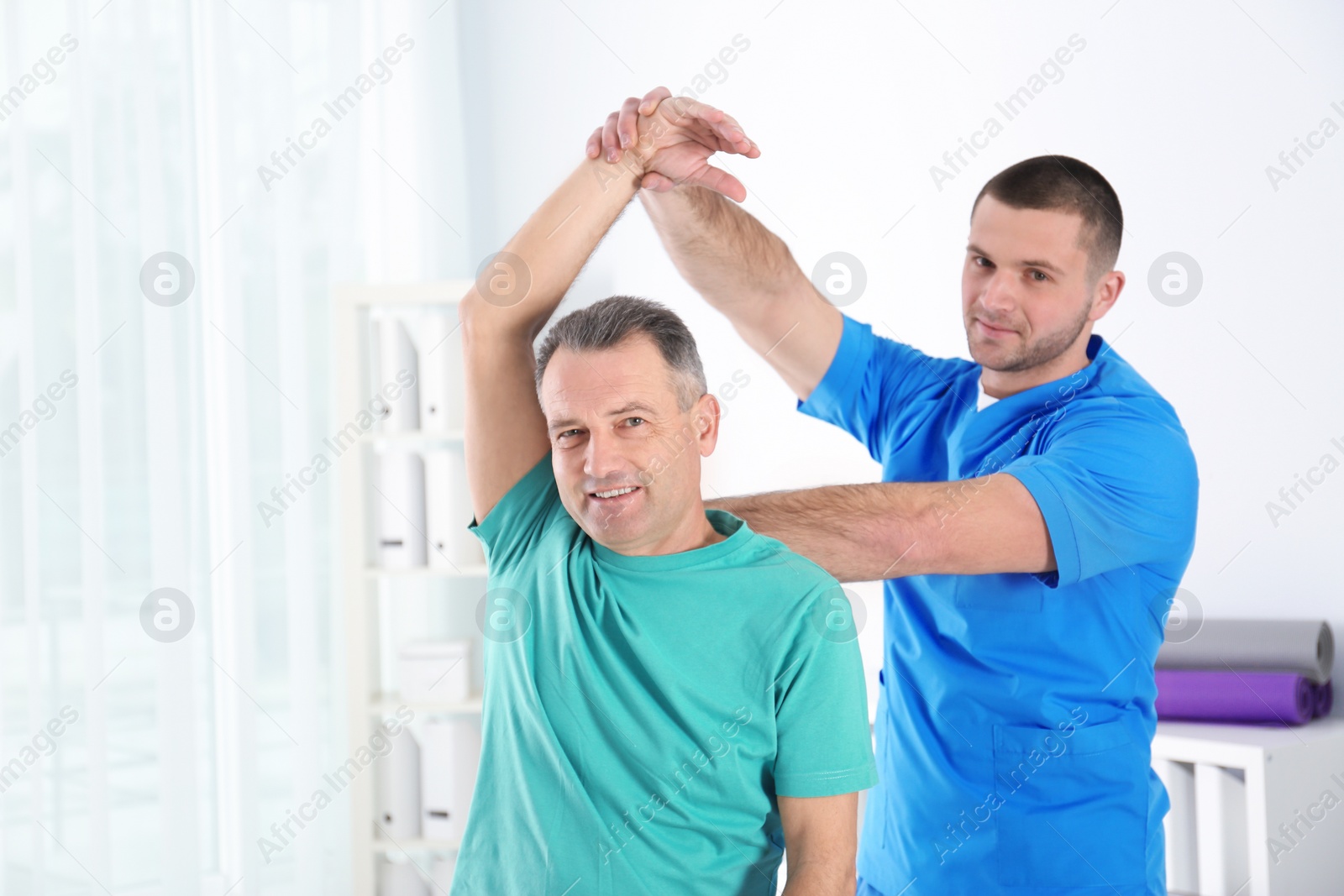 Photo of Doctor working with patient in hospital. Rehabilitation physiotherapy