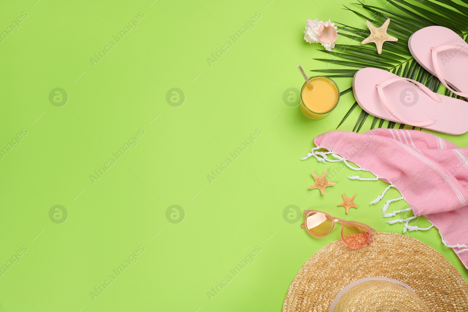 Photo of Flat lay composition with beach objects on green background, space for text