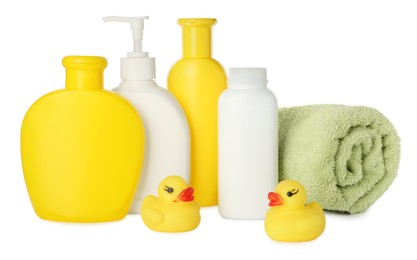 Photo of Bottles of baby cosmetic products, towel and rubber ducks on white background