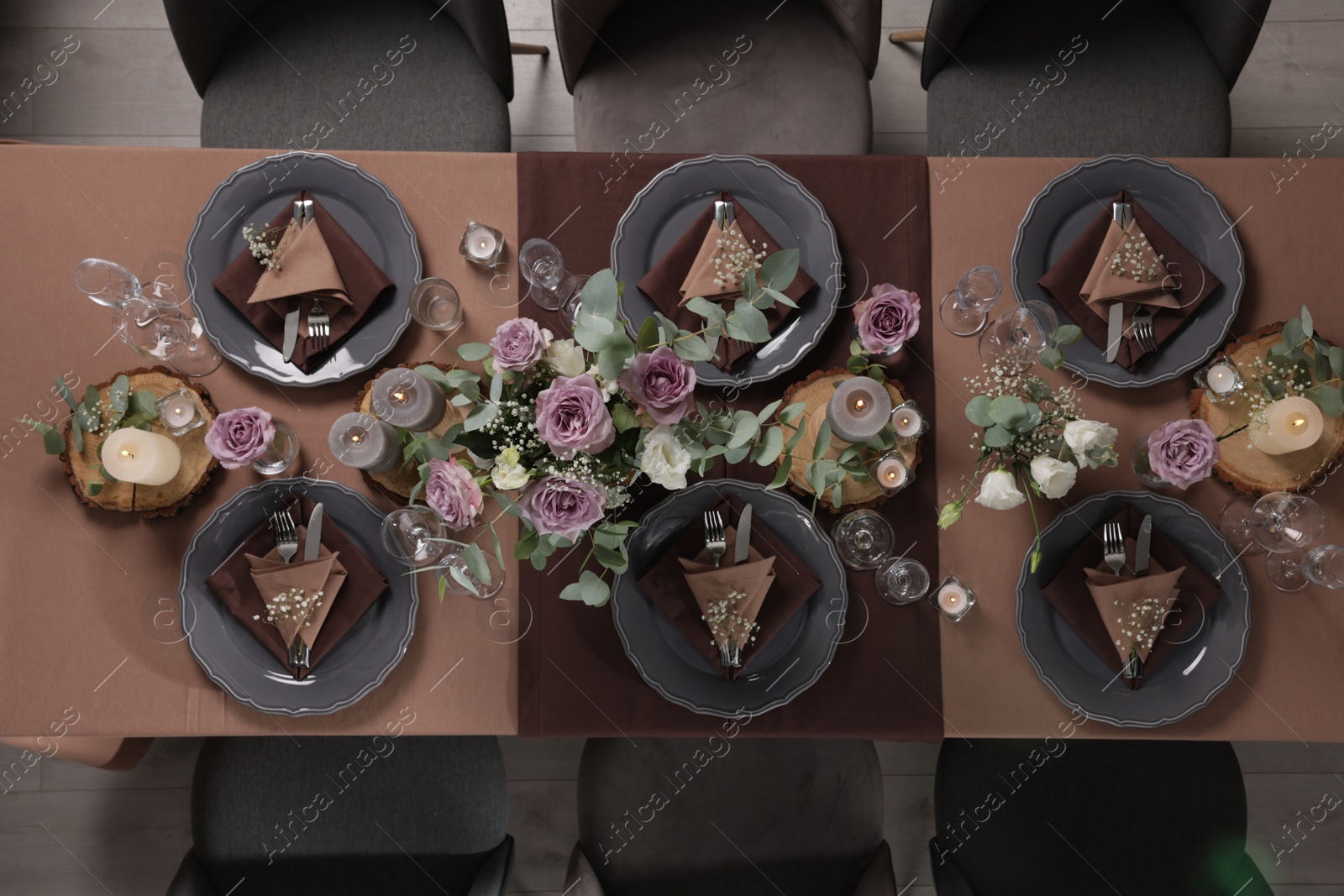 Photo of Elegant table setting with beautiful floral decor and burning candles, top view