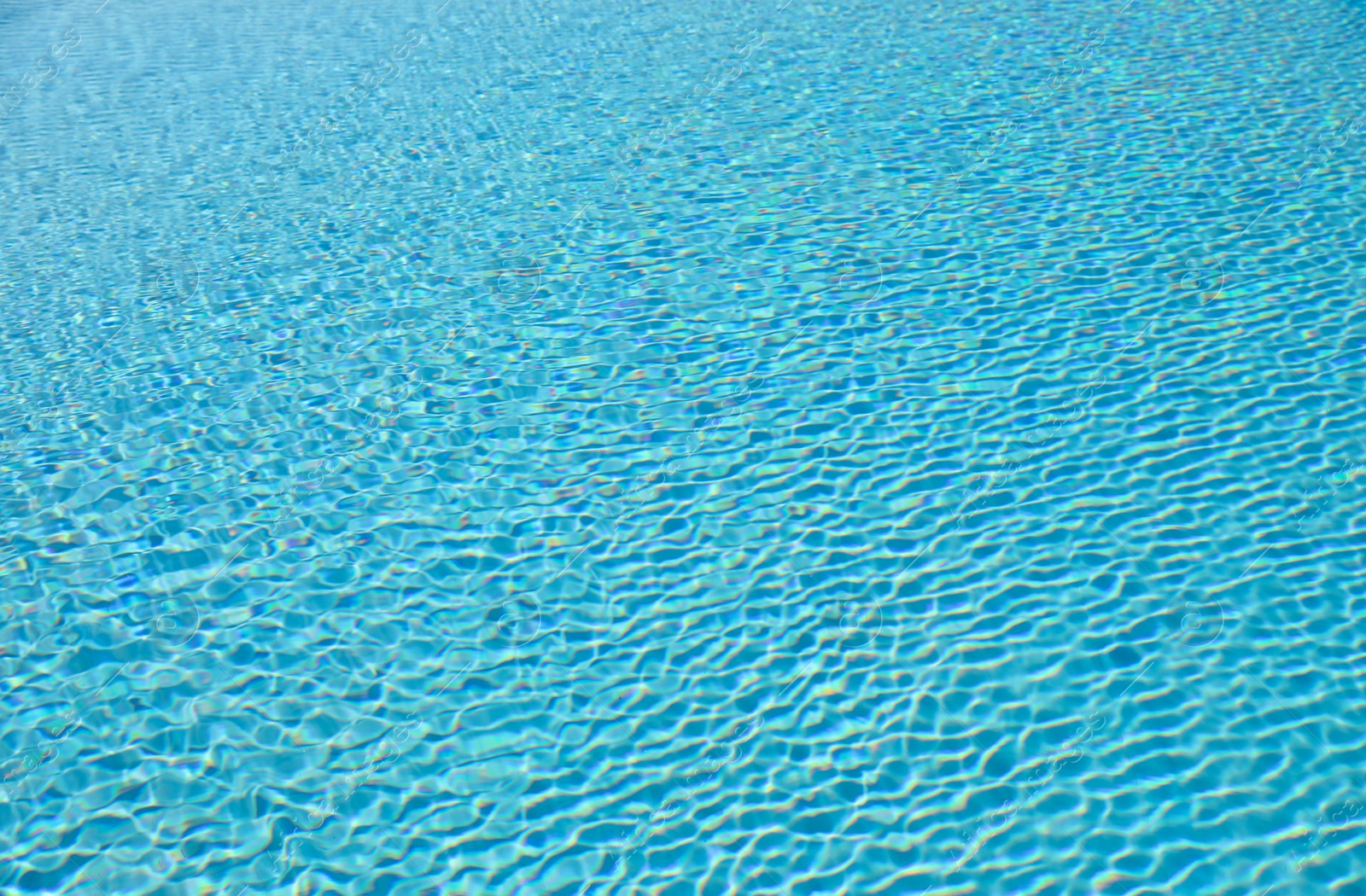 Photo of Swimming pool with clean blue water as background. Summer vacation