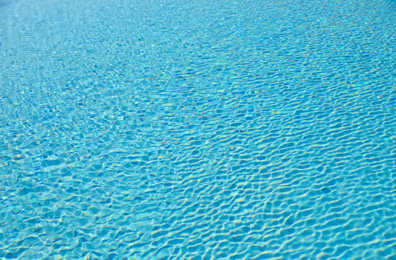 Photo of Swimming pool with clean blue water as background. Summer vacation