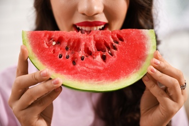 Photo of Beautiful young woman with watermelon slice, closeup