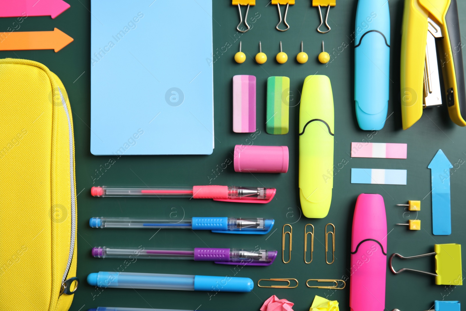 Photo of Flat lay composition with different school stationery on chalkboard surface