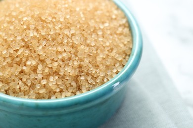 Photo of Brown sugar in bowl on table, closeup