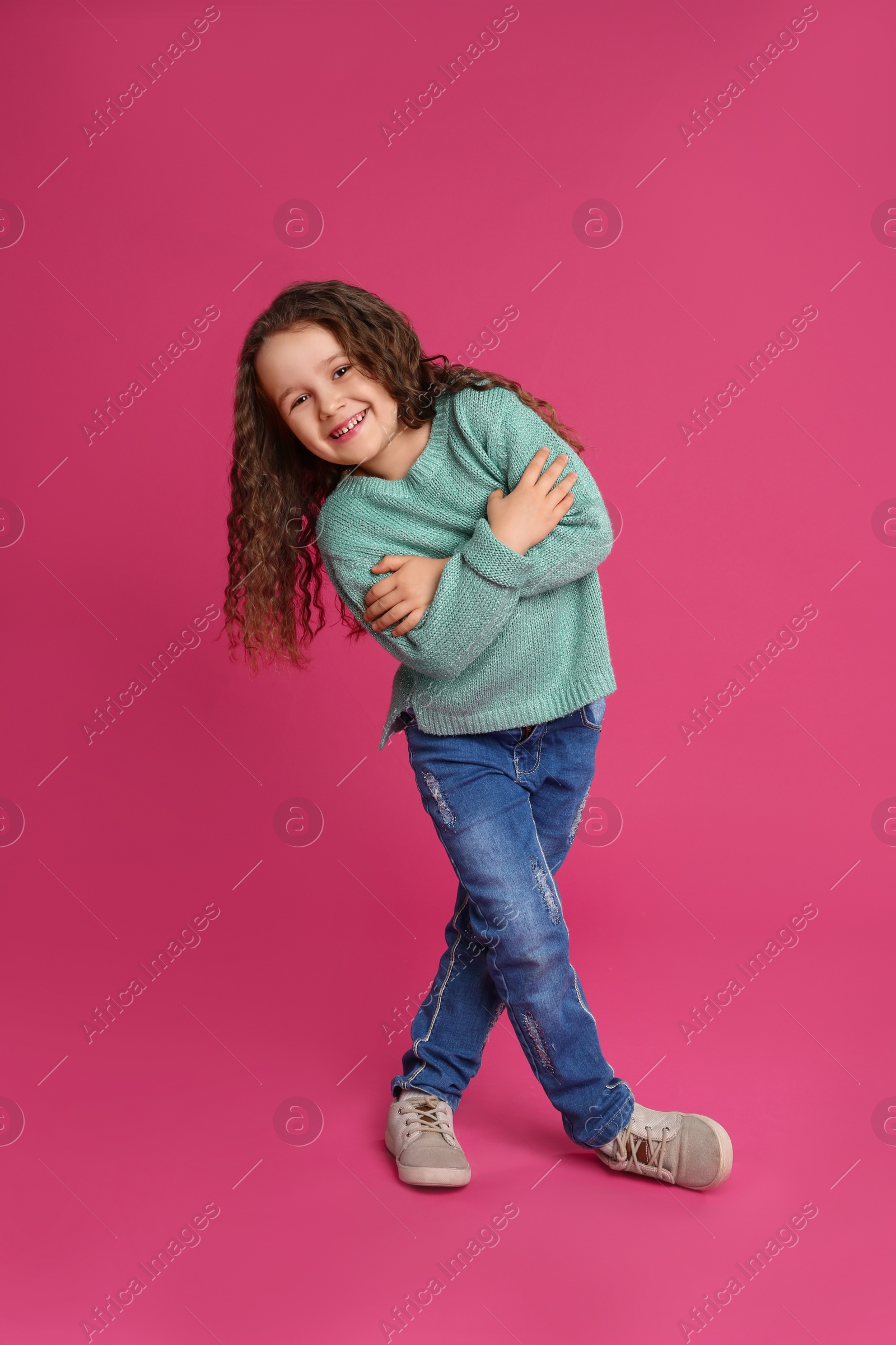 Photo of Full length portrait of cute little girl on pink background