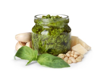 Photo of Jar of tasty pesto sauce and ingredients isolated on white