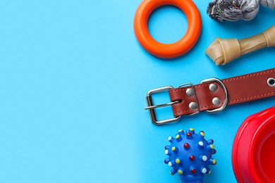 Photo of Flat lay composition with dog collar and different accessories on light blue background, space for text