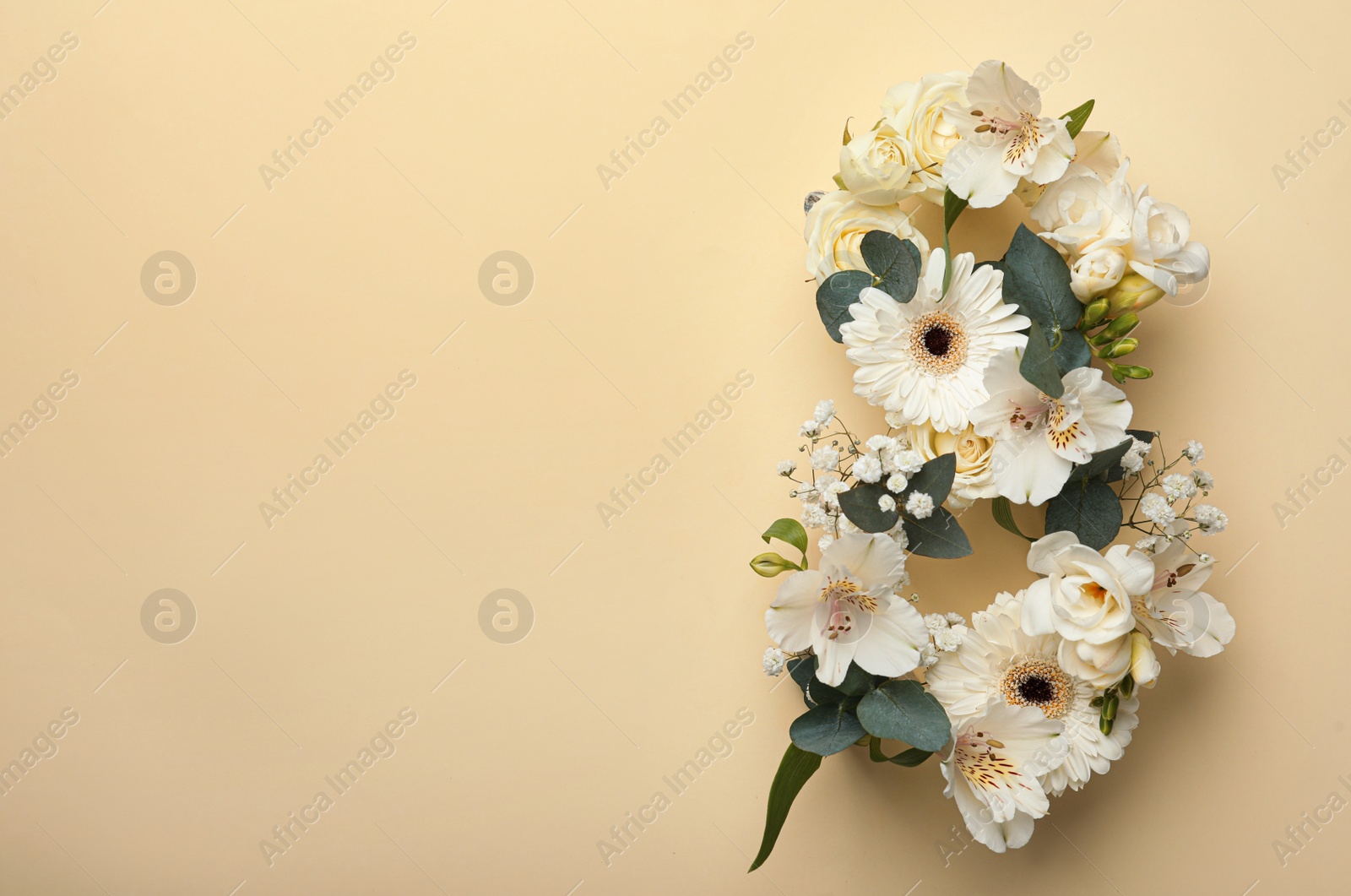 Photo of Number 8 made of beautiful white flowers on beige background, flat lay with space for text. International Women's day