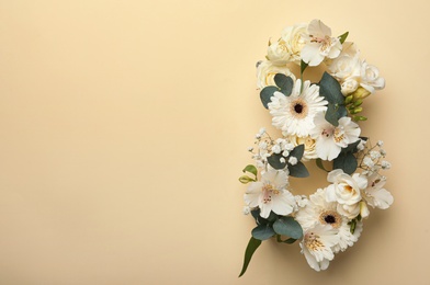 Number 8 made of beautiful white flowers on beige background, flat lay with space for text. International Women's day