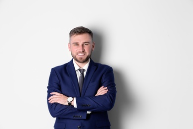 Portrait of happy man in office suit on white background